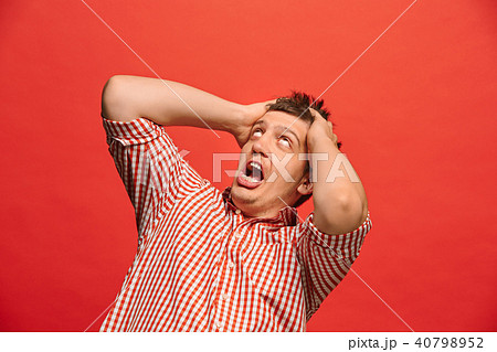 Portrait of the scared man on red 40798952