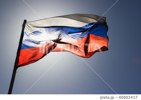 russian flag flying in slow motion and back lit by the sun. 40803437
