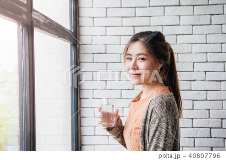 Lovely Asian Woman Relaxing in Cozy House 40807796