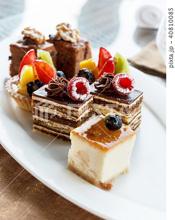 Set of mini cakes in assortment on white plate. 40810085