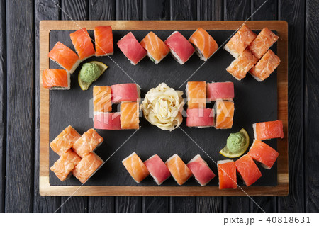 Big set of rolls served on stone plate. Big set of rolls served on stone plate. 40818631