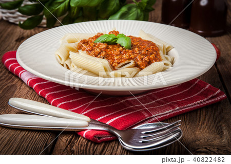 Penne a bolognese on white plate. Penne a bolognese on white plate. 40822482