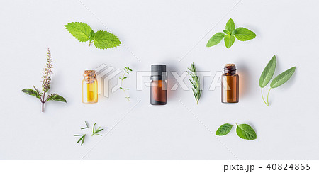 Bottle of essential oil with fresh herbal sage, ro 40824865