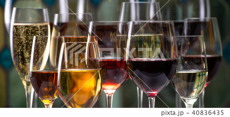 Champagne, white, rose and red wins and drinks in glasses on stained glass background Champagne, white, rose and red wins and drinks in glasses on stained glass background 40836435
