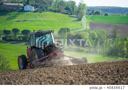 Tractor plowing field and beautiful landscape, France 40836617