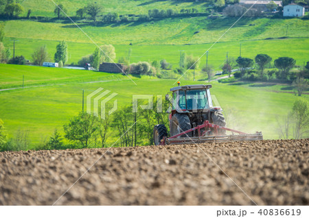 Tractor plowing field and beautiful landscape, France Tractor plowing field and beautiful landscape, France 40836619