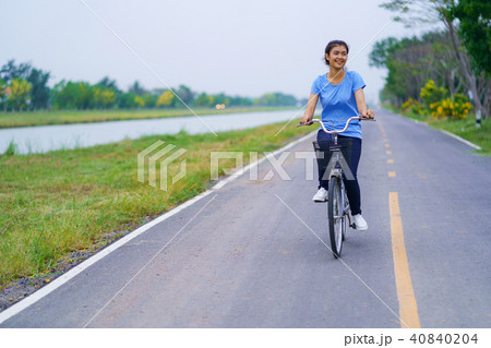 Girl with bike, Woman riding a bicycle on road Girl with bike, Woman riding a bicycle on road 40840204