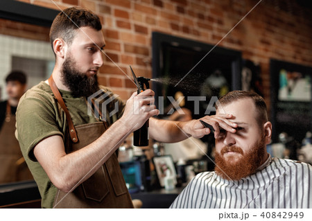 Barber and bearded man in barber shop 40842949