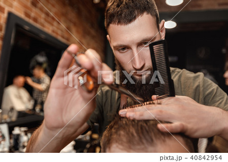 Barber and bearded man in barber shop Barber and bearded man in barber shop 40842954