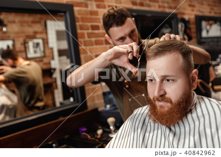 Barber and bearded man in barber shop Barber and bearded man in barber shop 40842962