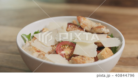 parmesan flakes falling on caesar salad parmesan flakes falling on caesar salad 40844796