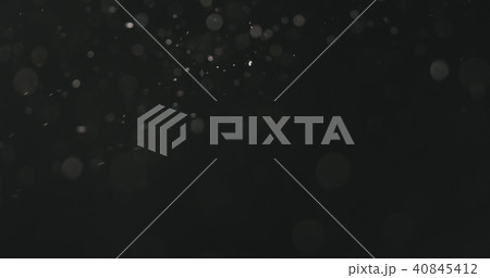dust particles floating over black background with motion blur 40845412