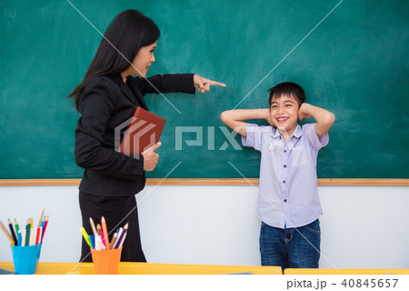 boy close ears by hand and smile with his teacher boy close ears by hand and smile with his teacher 40845657