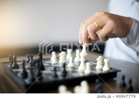 Businessman thinking how to play chess Businessman thinking how to play chess 40847779
