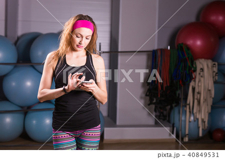 Sporty young woman with fitness tracker in gym Sporty young woman with fitness tracker in gym 40849531