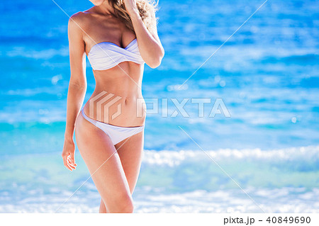 Tanned woman body in white bikini 40849690