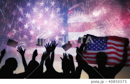 Silhouettes of people holding the Flag of the USA. 40850373