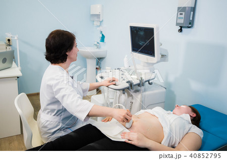 Pregnant woman doing ultrasound scan in the prenatal clinic, mother worried about health of her 40852795
