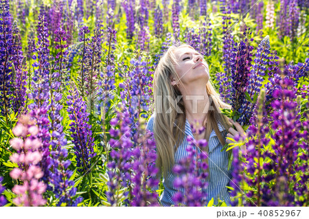 A girl is enjoys flowers 40852967