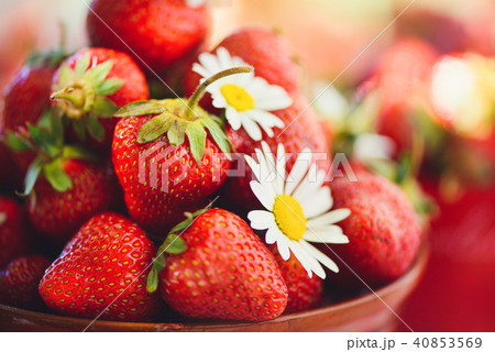 A fresh strawberry in a bowl on table in a summer A fresh strawberry in a bowl on table in a summer 40853569