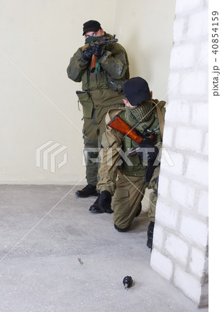 insurgents with AK 47 throws a grenade 40854159