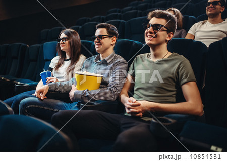 People with popcorn watching movie in cinema People with popcorn watching movie in cinema 40854531