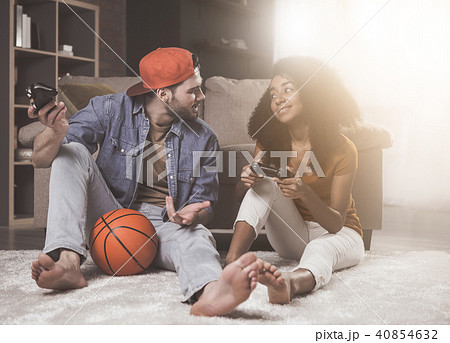 Cheerful young male and female are enjoying video game Cheerful young male and female are enjoying video game 40854632