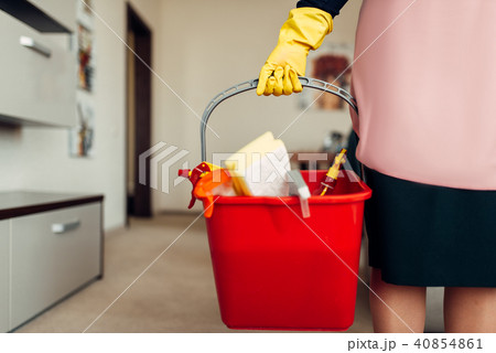 Housemaid hands in gloves holds cleaning equipment 40854861