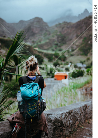 Female hiker takes a picture of misty Paul valley. Clouds boiling over the ridges of Santo Antao 40855714