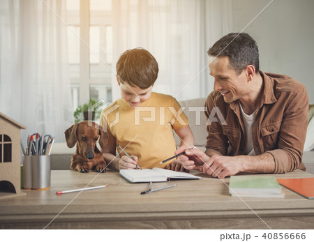 Happy father and son doing art near dog Happy father and son doing art near dog 40856666