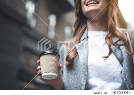 Young cheerful woman is holding cup of coffee 40858840
