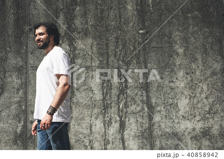 Smiling guy being fond of walking around deserted areas 40858942