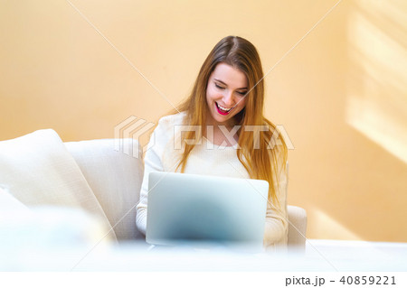 Young woman using her laptop computer 40859221