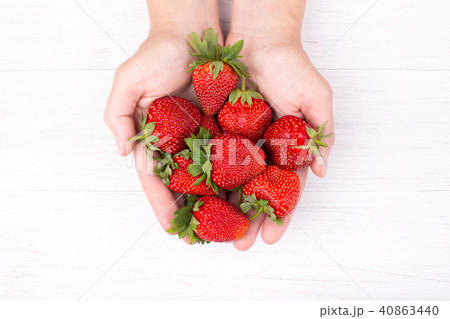 Womans hands holding srawberries. Womans hands holding srawberries. 40863440