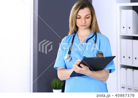 Woman doctor at work in hospital office. Portrait of female physician. Medicine and health care Woman doctor at work in hospital office. Portrait of female physician. Medicine and health care 40867376