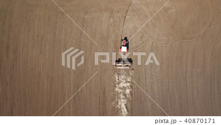 Aerial view tractor in the field, spring works 40870171