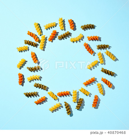 Round frame of macaroni with copy space on a blue background. Flat lay. Round frame of macaroni with copy space on a blue background. Flat lay. 40870468