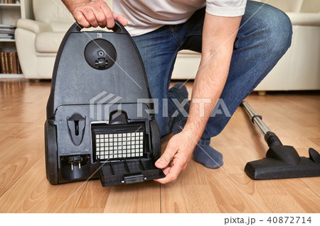 Replacing a hepa filter in vacuum cleaner at home. 40872714