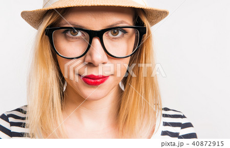 Portrait of a young beautiful woman with a hat in studio. Close up. Portrait of a young beautiful woman with a hat in studio. Close up. 40872915