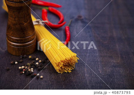 Spaghetti on a dark wooden background. 40873793