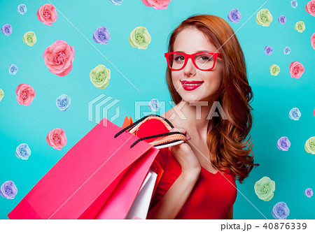 redhead girl in eyeglasses with shopping bags 40876339