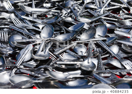 Pile of various stainless spoons and forks Pile of various stainless spoons and forks 40884235