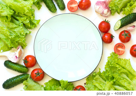 Healthy fresh vegetables for salad around plate. Healthy fresh vegetables for salad around plate. 40886057