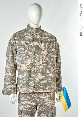 Mannequin in soldier uniform is holding ukrainian flag. Mannequin in soldier uniform is holding ukrainian flag. 40887324