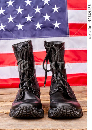 Military soldier boots against american flag background. Military soldier boots against american flag background. 40889128