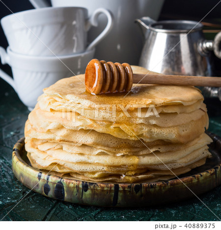 Stack of crepes with poured honey Stack of crepes with poured honey 40889375