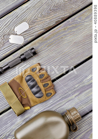 Military bottle, glove, flashlight, and dog tags. Military bottle, glove, flashlight, and dog tags. 40889398