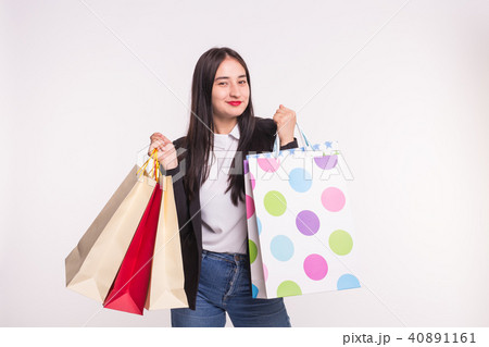 Portrait of young happy brunette woman with shopping bags on white background Portrait of young happy brunette woman with shopping bags on white background 40891161