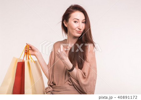 Portrait of young happy smiling woman with shopping bags on white background 40891172