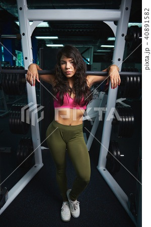 Woman standing in gym background 40891582